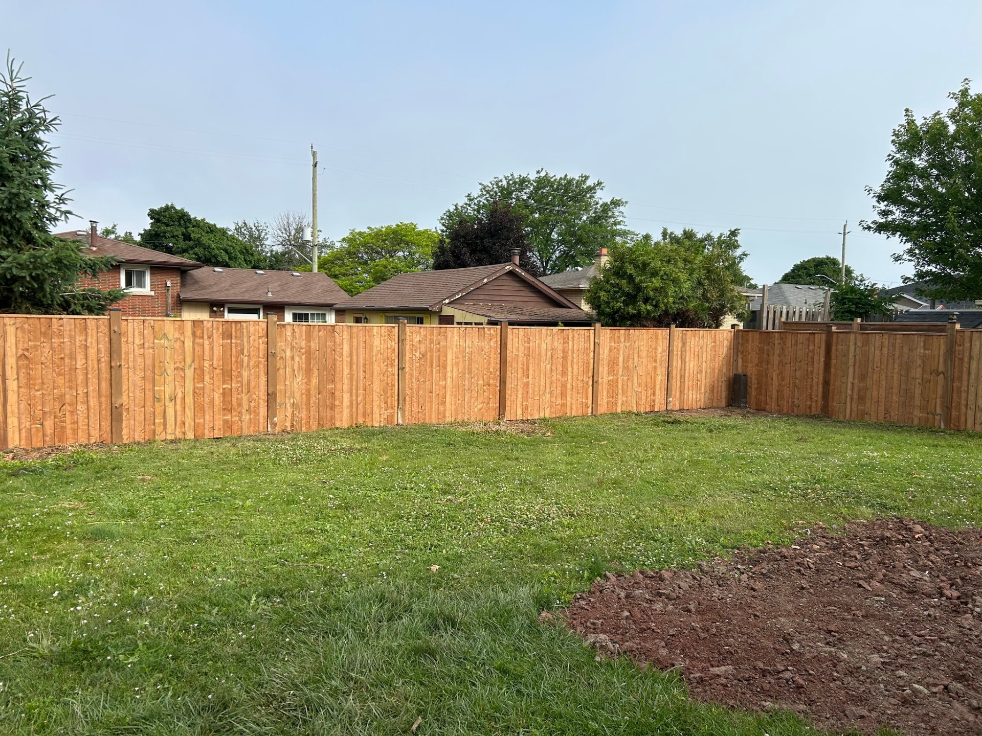 Wood fence installation project in Toronto backyard